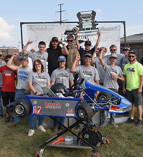 Black cat racing team with trophy and vehicle