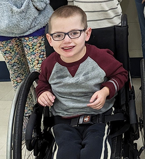 Cute elementary boy in wheelchair