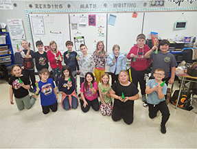 Group of students posing for a picture in their classroom