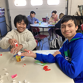 Two boys having fun with play dough in the classroom