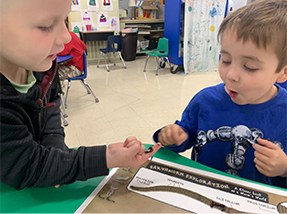 Two little boys working on a puzzle
