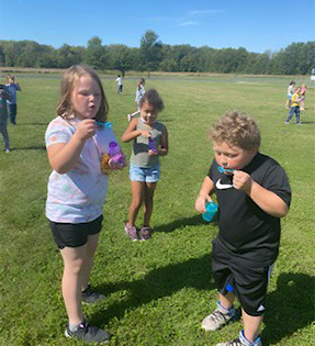 3 students blowing bubbles