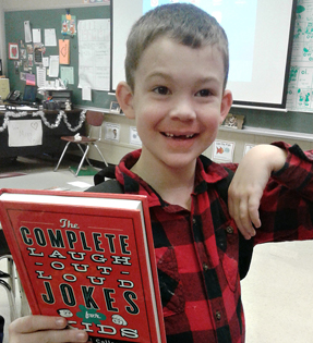 boy holding a joke book