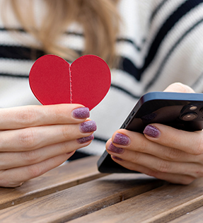 Woman reading information on school website using her mobile phone.