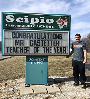 Mr Castetter next to sign donated by the PTO the reads Congratulations Mr Castetter Teacher of the Year