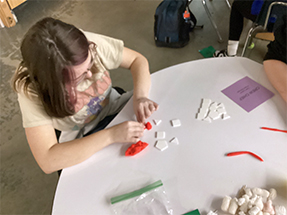 Girl working with tiles at a round table in the classroom